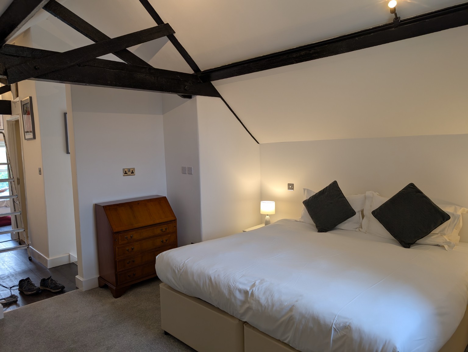 The Hayloft: the main bedroom, with a king bed beneath the exposed beams.